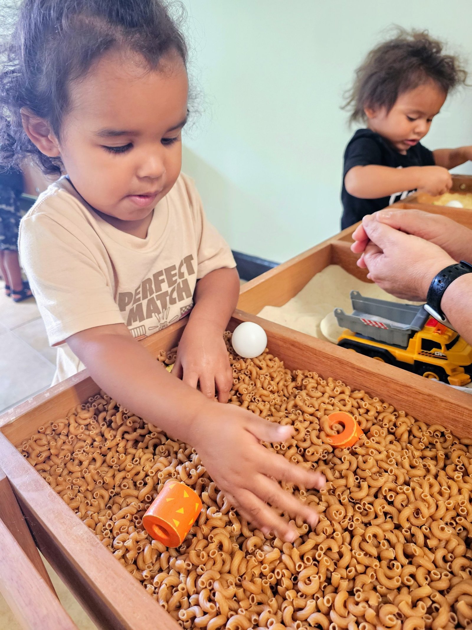 photo of student playing in sensory bin